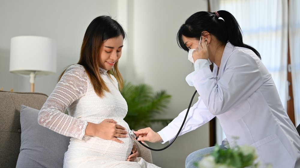 Professional,Asian,Female,Doctor,Or,Obstetrician,Listening,Baby's,Heartbeat,By